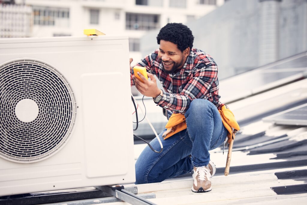 AC maintenance for consistent cooling with technician servicing air conditioner unit