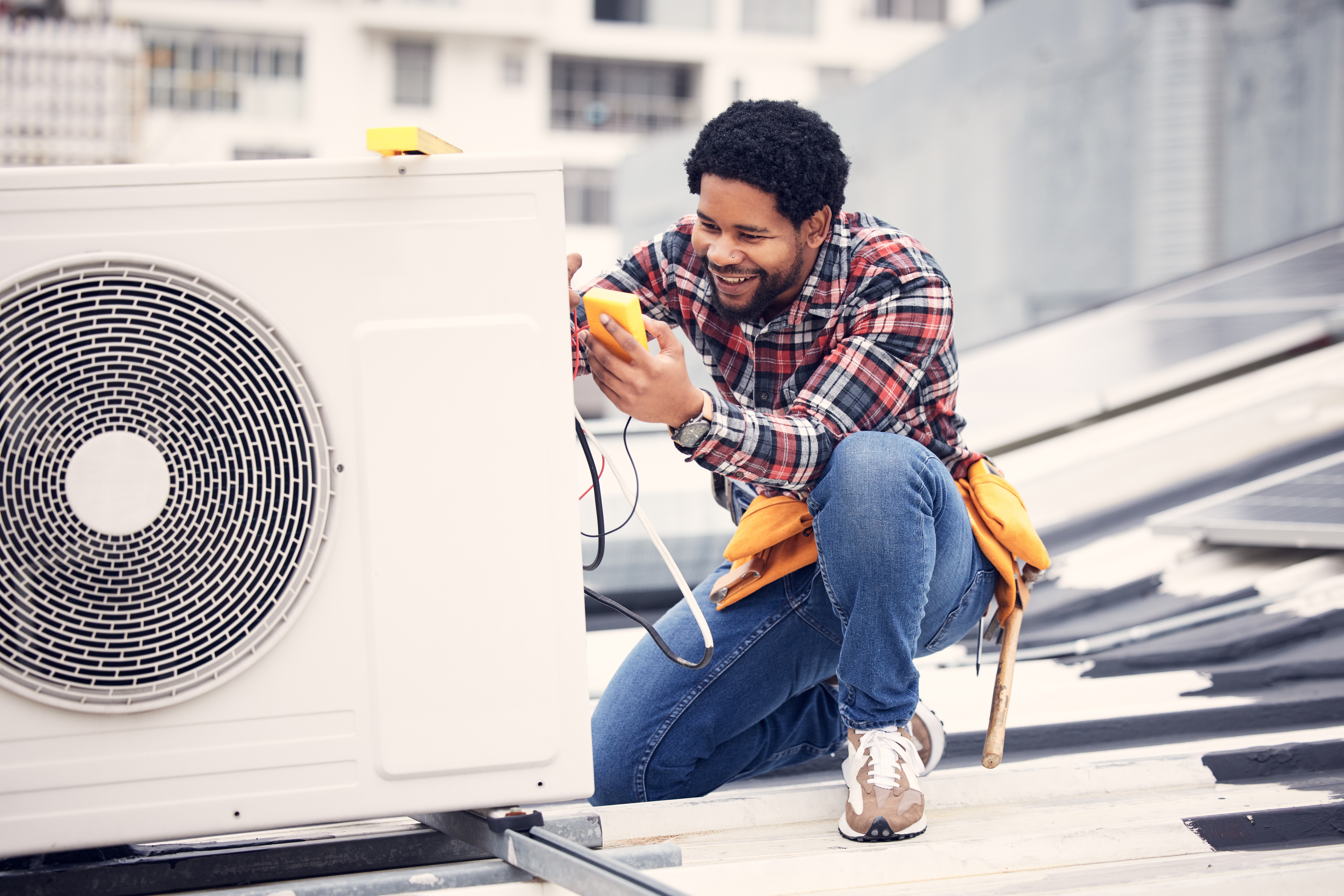 AC maintenance for consistent cooling with technician servicing air conditioner unit