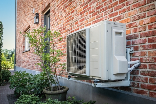 Comparison of central AC system and ductless mini split unit installed in residential home interiors