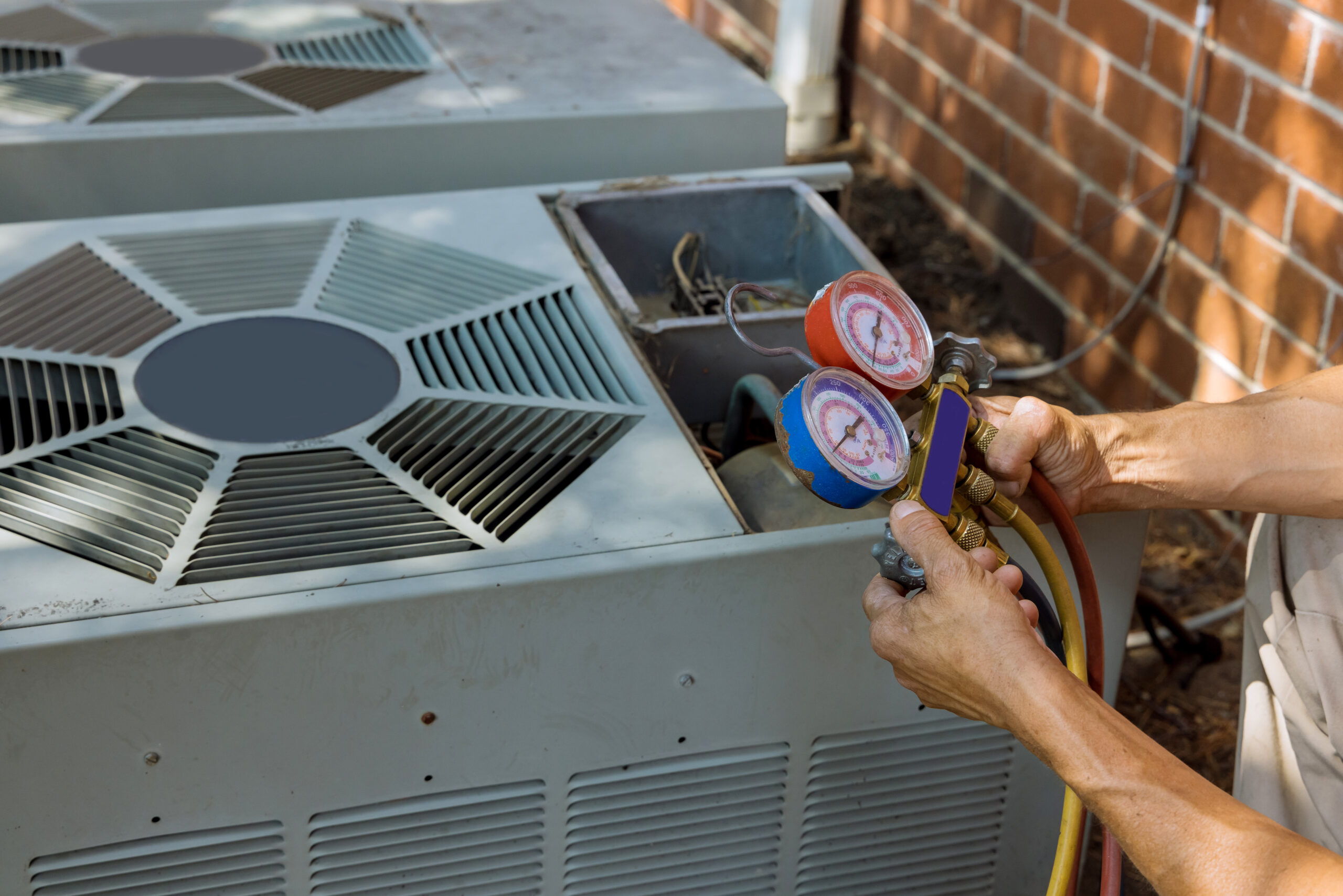 HVAC technician inspecting electrical components after a homeowner reports that their AC smells like burning plastic, indicating a potential electrical HVAC failure.